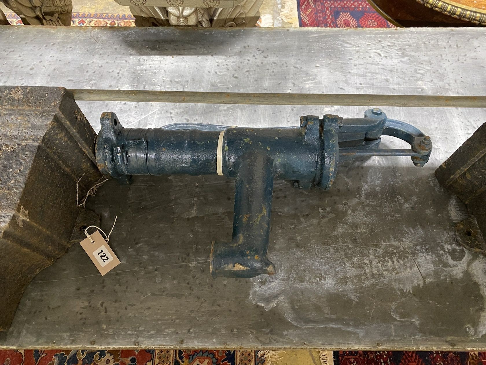 A pair of Victorian cast iron hoppers and a water pump